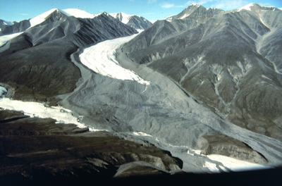 Stagnation Glacier. Note the light-colored 'bathtub ring' against the darker, lichen-covered rock.