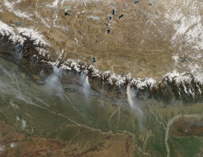 On March 12, 2009, the Moderate Resolution Imaging Spectroradiometer (MODIS) on NASA’s Aqua satellite caught a glimpse of a relatively rare event: large–scale forest fires in the Himalaya Mountains of Nepal. The numerous small fires in southern Nepal may not be wildfires, but rather agricultural or other land-management fires. ... conditions during the fall and winter of 2008 and 2009 were unusually dry, and fires set by poachers to flush game may have gotten out of control.