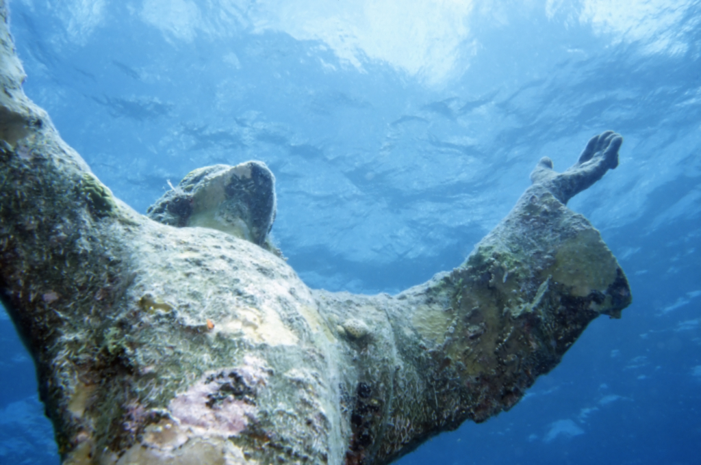 Close-up photo of the thirty foot statue in John Pennekamp Coral Reef State Park in Florida of the “Christ of the Abyss” statue, a replica of a statue in the Mediterranean Sea. Photo: Getty Images / iStockphoto