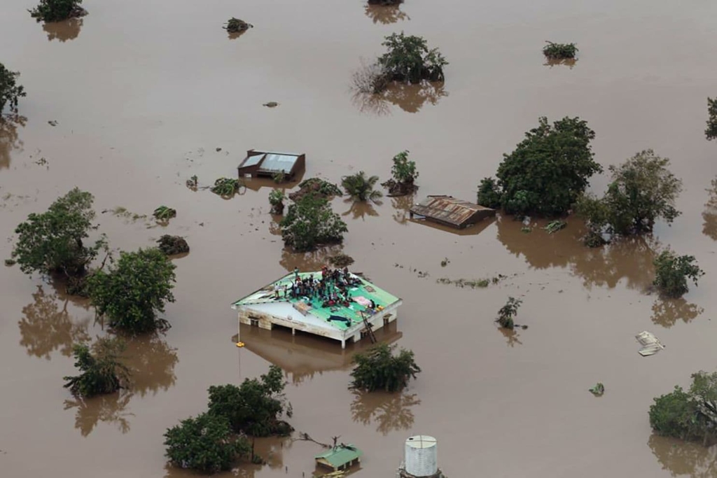 People await rescue on a roof in Beira, Mozambique, after flooding from Cyclone Idai, 18 March 2019. Photo: Rick Emenaket / Mission Aviation Fellowship / AFP / Getty Images