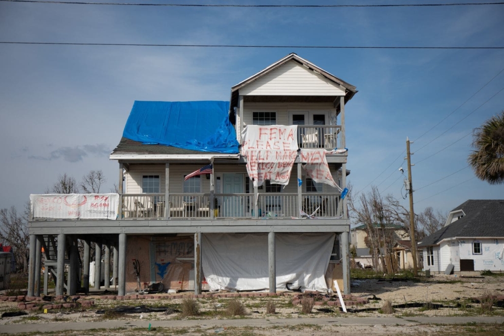 Six months after Hurricane Michael, residents of the Florida Panhandle continue to live in damaged homes or trailers unfit for human habitation. A handmade sign on a damaged house reads, “FEMA please help make Mexico Beach great again”. Photo: Charlotte Kesl / The Washington Post