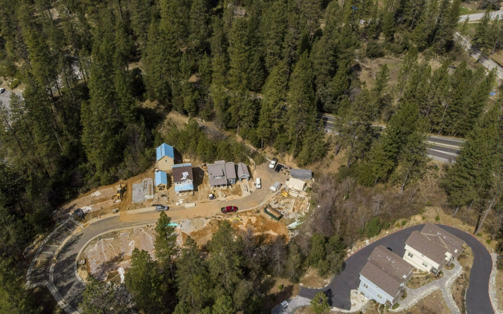 Aerial view of a housing development off Chief Kelly Drive in Nevada City, California, that is under construction on 14 March 2019. California cities continue to build homes in areas of high wildfire risk. City officials agree that the wooded draws, steep hillsides, narrow residential streets, ancient homes and thick urban tree canopy that define the character of the city also make it particularly at risk if a fire burns through. Photo: Hector Amezcua / The Sacramento Bee / AP