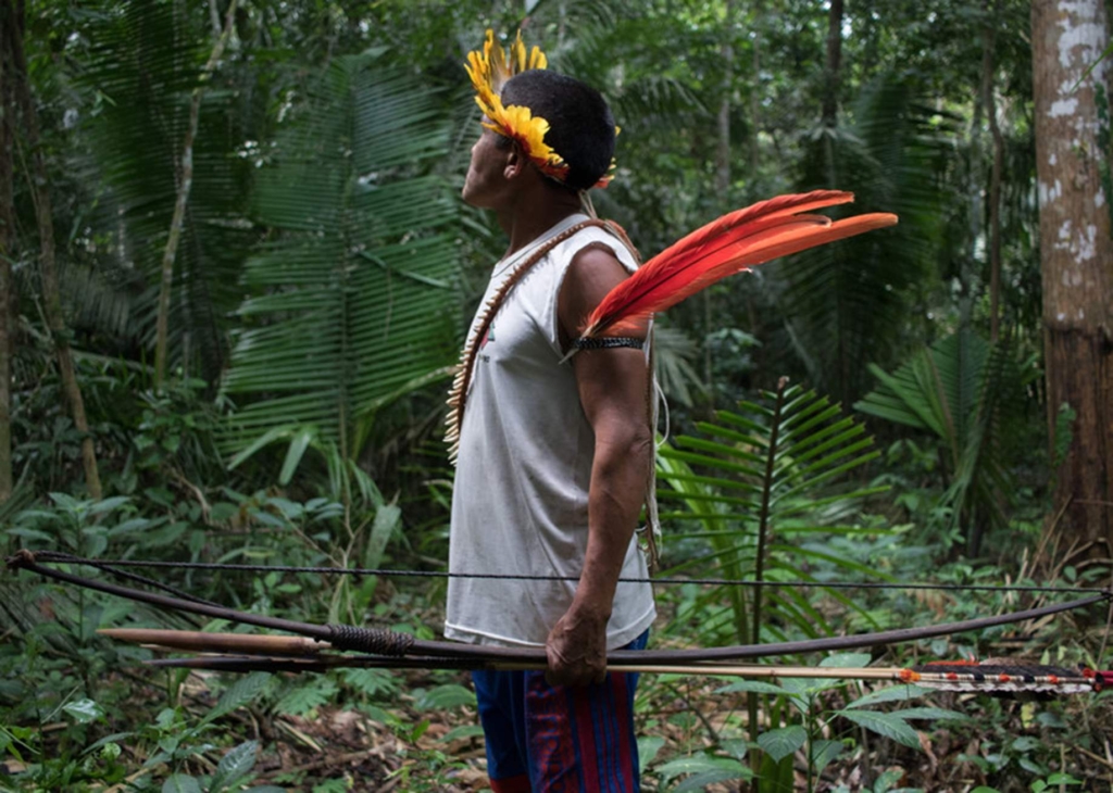 An Indigenous man patrols the forest in Uru-Eu-Wau-Wau territory in Rondônia state, Brazil. Photo: Gabriel Uchida / Amnesty International