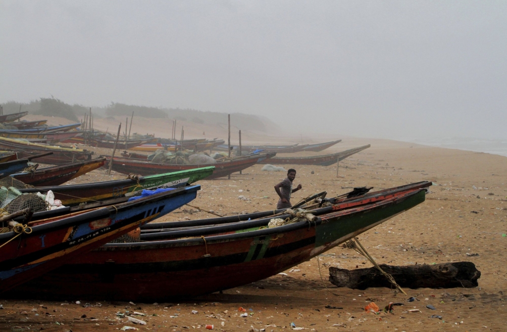An Indian fisherman runs between the docked fishing boats amid strong winds at Chandrabhaga beach in Puri district of eastern Odisha state, India, Thursday, 2 May 2019. Hundreds of thousands of people were evacuated along India's eastern coast on Thursday as authorities braced for a cyclone moving through the Bay of Bengal that was forecast to bring extremely severe wind and rain. Photo: AP Photo