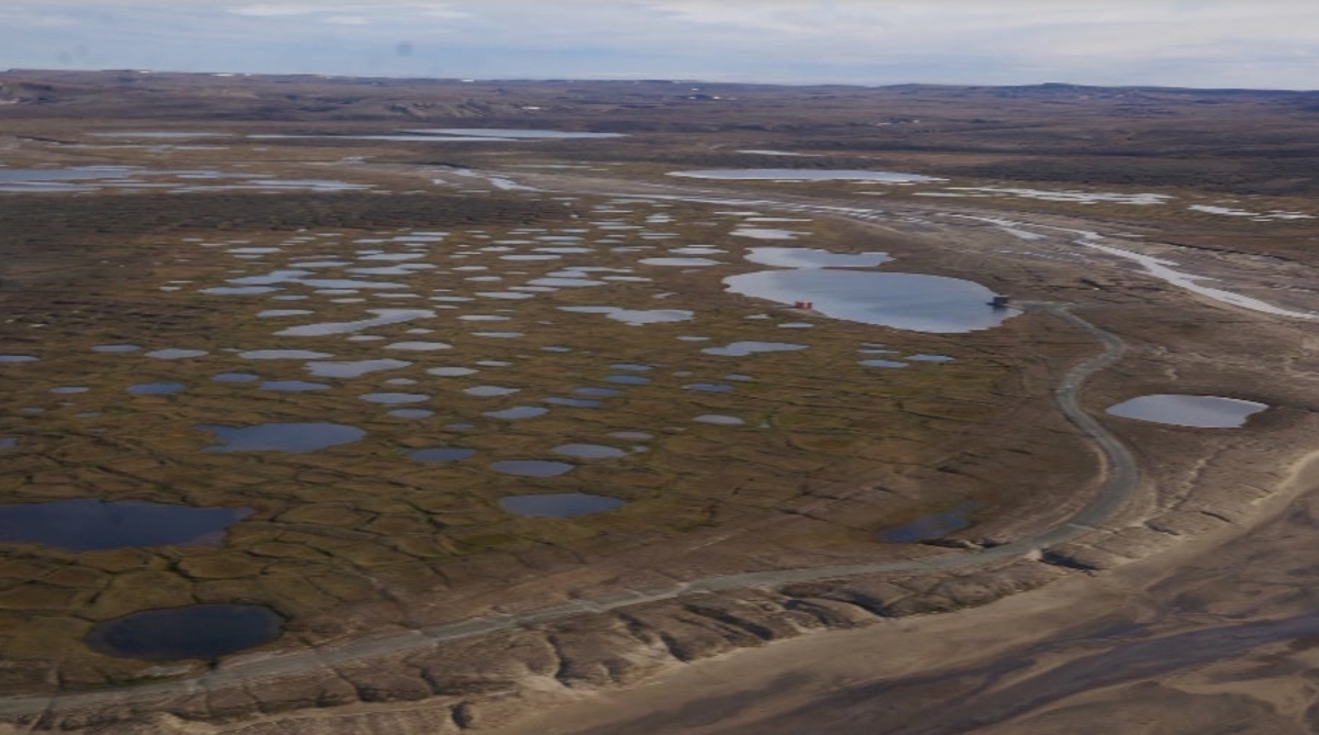 Aerial view of melting permafrost near a research site in Arctic Canada. The unprecedented melt rate creates thermokarst, an irregular landscape dotted by lakes, holes, and mounds. Photo: Louise Farquharson