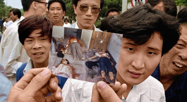 After the Tiananmen Square massacre on 3 June 1989, protesters display photos of bodies at a morgue. Photo: Jeff Widener / AP