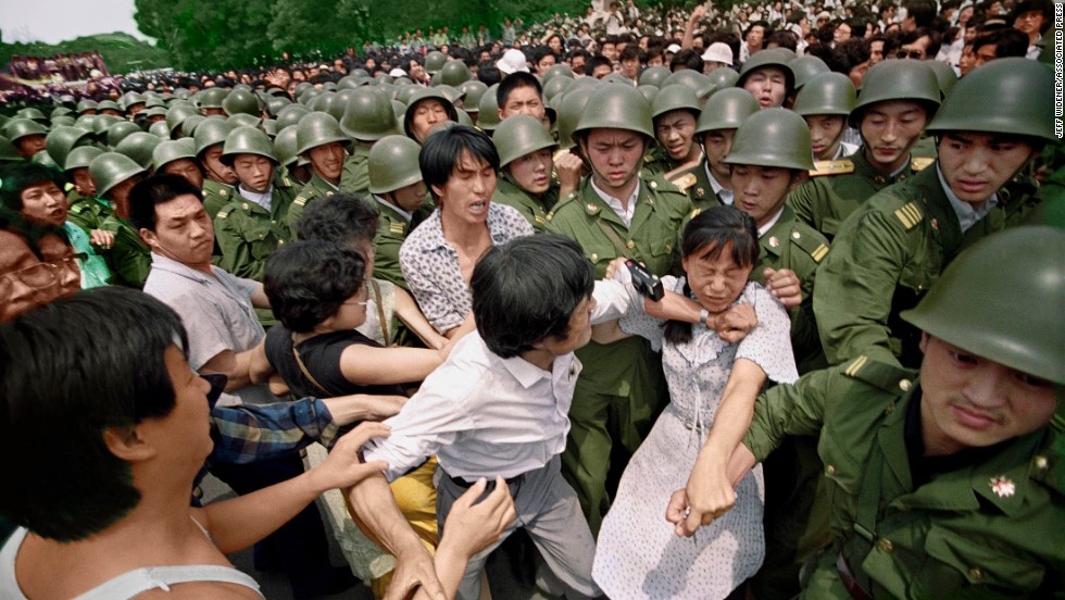 A young woman is caught between civilians and People’s Liberation Army soldiers who are trying to remove her from an assembly near the Great Hall of the People, on the west side of Tiananmen Square in Beijing, China, on 3 June 1989. Photo: Jeff Widener / AP