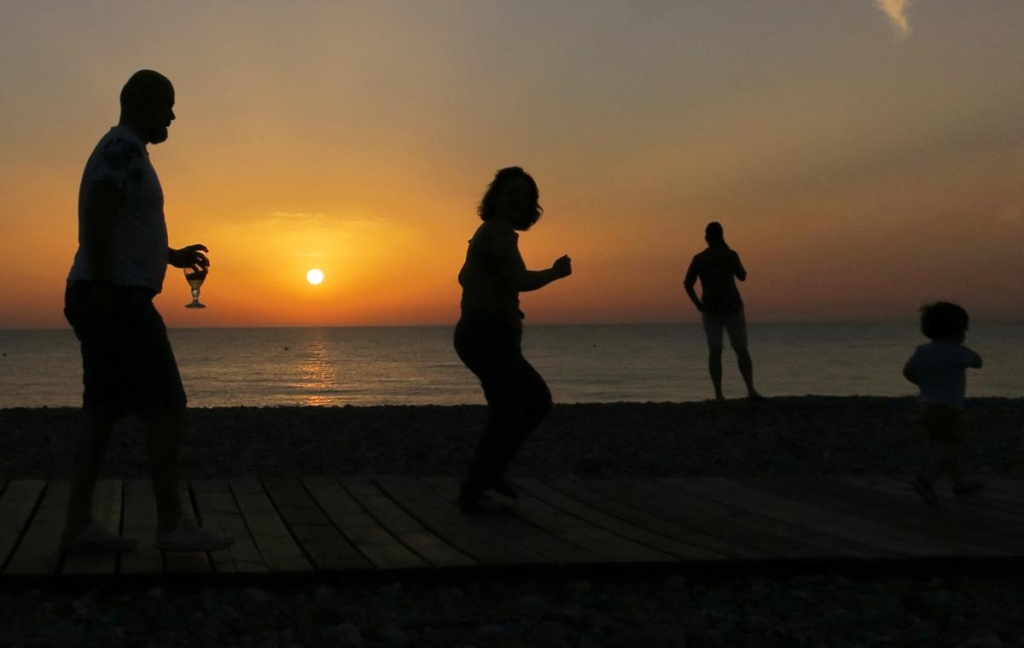 People enjoy sunset on the beach, as the record-breaking heatwave hits France, in Cayeux-sur-Mer, France, 28 June 2019. Photo: Pascal Rossignol / REUTERS