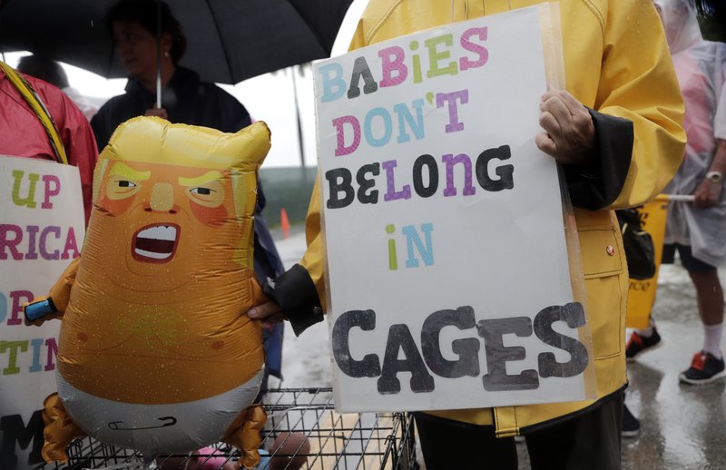 Protesters hold an inflatable doll in the likeness of President Donald Trump outside of the Homestead Temporary Shelter for Unaccompanied Children in Homestead, Florida, 16 June 2019. A coalition of religious groups and immigrant advocates said they want the Homestead detention center closed. Photo: Lynne Sladky / AP Photo