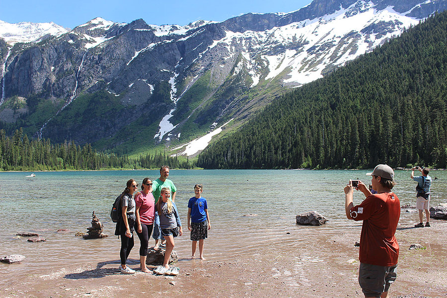 Tourists take the obligatory photos after hiking to Avalanche Lake in Glacier National Park. The lake is fed by cascading waterfalls fed by Sperry Glacier, which has shrunk from 331 acres in 1966 to less than 200 acres today. Photo: Doug Struck