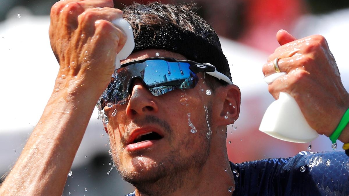 Triathlete Jan Frodeno of Germany tries to cool down on his way to win the Ironman triathlon European Championships in Frankfurt, Germany, 30 June 2019. Photo: Kai Pfaffenbach / REUTERS