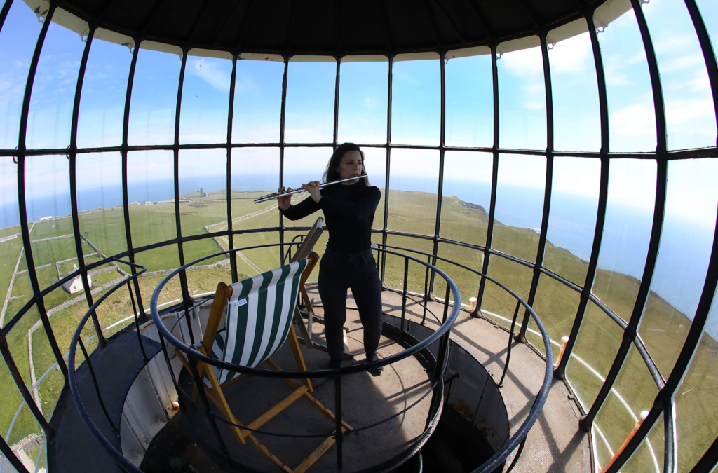 Carolyn Byrne, a lawyer from Manhattan, says she felt like she hadn’t had time to play her flute or just stare at the sky in years. She got the chance to do both at the top of the Old Light lighthouse during the Cloud Appreciation Society's gathering on Lundy, England. Photo: Phil Noble / Reuters