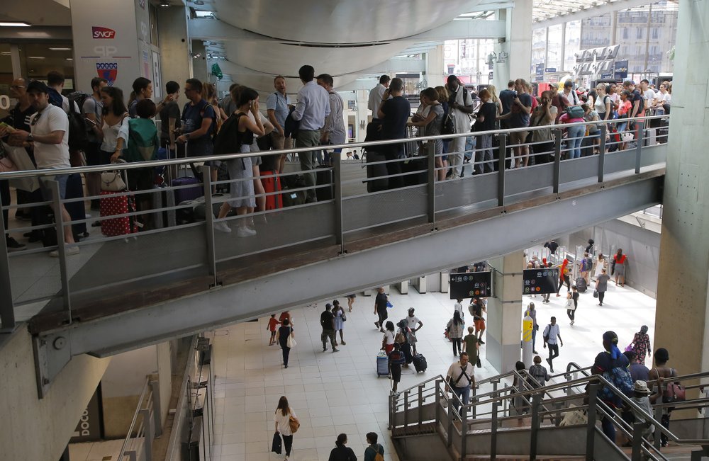 People queue for train services inside the Gare du Nord train station in Paris, Friday, 26 July 2019, during Europe’s record-breaking heatwave. A power outage at one of France's busiest train stations disrupted travel on the Eurostar to and from London and other routes around the region. Photo: Michel Euler / AP Photo