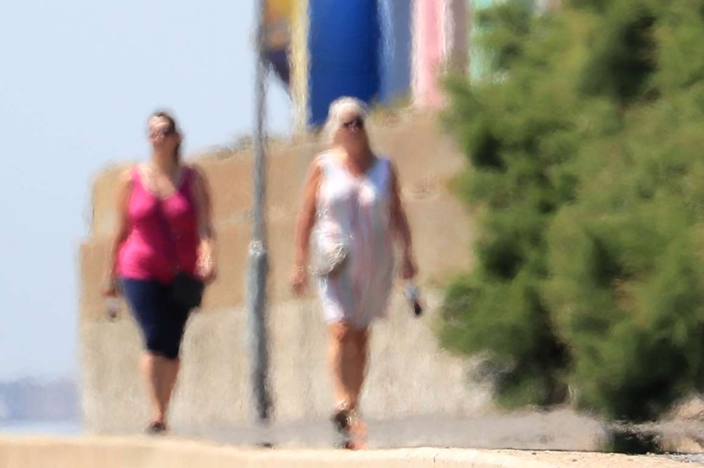 Two ladies, seen through heat haze, walk on the promenade in Folkestone, England on 23 July 2019. Photo: Gareth Fuller / PA Images / Getty Images