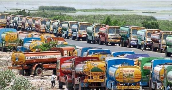 Water delivery trucks parked by a road in India. During the drought of 2019 in Chennai, violence against water supply truckers has broken out and drivers are often attacked by villagers. Photo: The Star