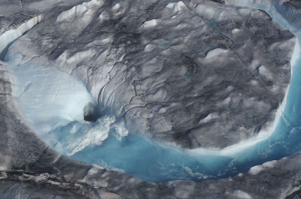 In this image taken on Thursday  1 August 2019 large rivers of melting water form on an ice sheet in western Greenland and drain into moulin holes that empty into the ocean from underneath the ice. The heat wave that smashed high temperature records in five European countries passed over Greenland, accelerating the melting of the island’s ice sheet and causing massive ice loss in the Arctic. Photo: Caspar Haarløv / Into the Ice / AP