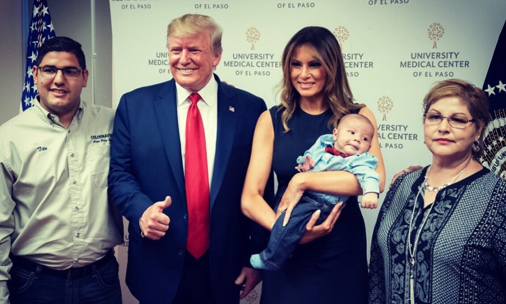 First Lady Melania Trump holds the two-month-old son of Jordan and Andre Anchondo, who were killed in the El Paso shooting last week, as she and President Donald J. Trump pose for photos and meet members of the Anchondo family on 7 August 2019 at the University Medical Center of El Paso in El Paso, Texas. Both are smiling as President Trump gives a thumbs-up. Jordan and Andre Anchondo were among the 22 people killed in a mass shooting on 3 August 2019 at a Walmart in El Paso. Photo: Andrea Hanks / White House