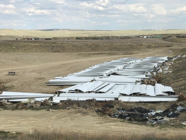 Windmill fan blades and motor housing components wait for disposal at the Casper Regional Landfill, 7 August 2019. Some 1,000 pieces from decommissioned wind turbines will be disposed of at the CRL by 2020, bringing an estimated $675,485 in new revenue to the landfill. Photo: Casper Regional Landfill