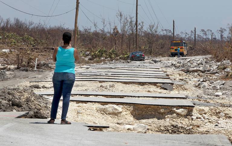 A bus holding 10 representatives from the Bahamas Ministry of Works maneuvers around a stretch of Grand Bahama Highway destroyed by Hurricane Dorian near the island’s East End on Friday, 6 September 2019. Photo: The Miami Herald