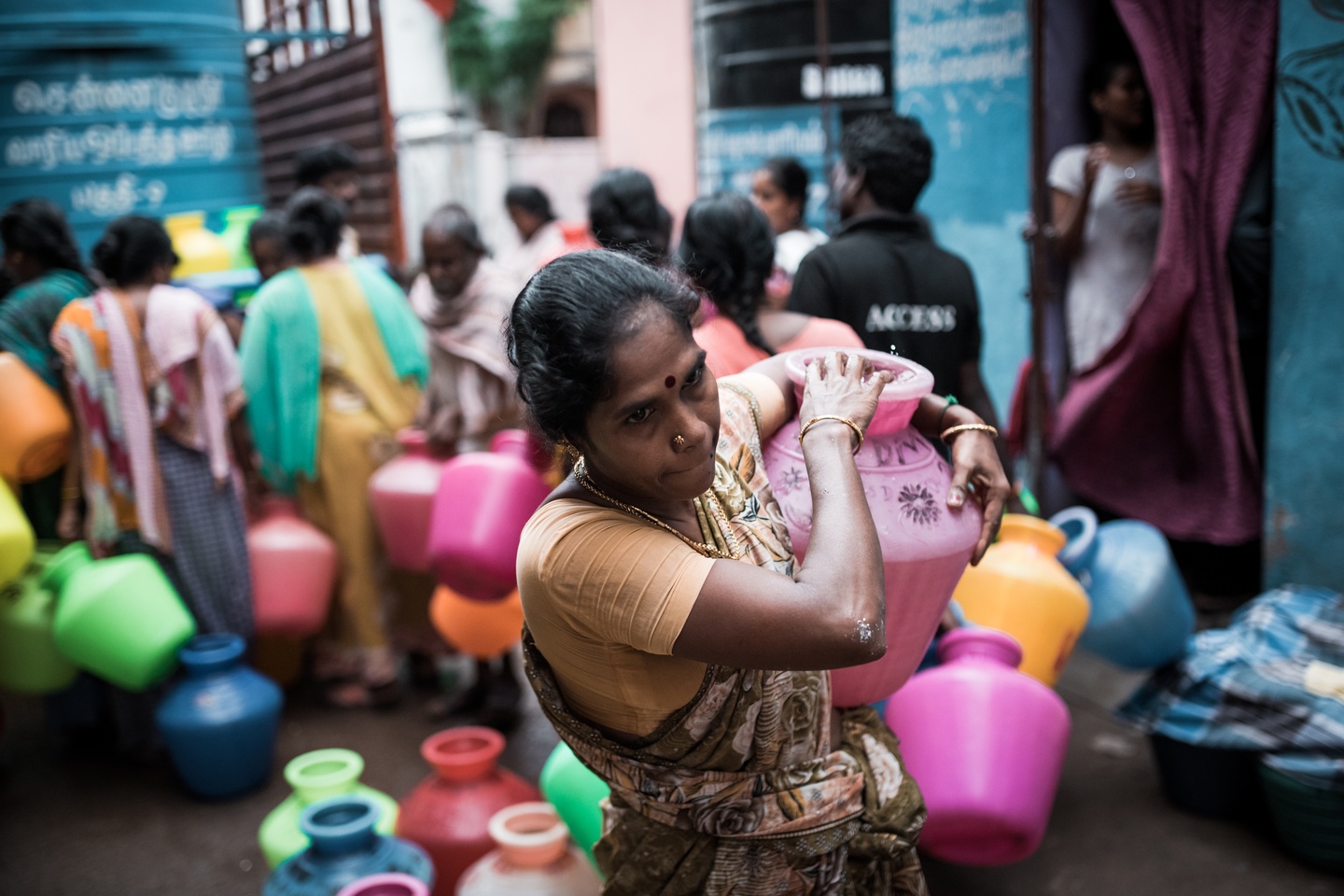 A resident of Lighthouse, an informal settlement in Chennai, carries a water pot back to her house in August 2019. “It is part of India’s social culture that the woman looks after everything related to the household. Collecting water and then carrying it up to the family’s apartment is, unfortunately, her burden,” said Krishna Mohan, chief resilience officer at 100 Resilient Cities (100RC), a non-profit organisation. Photo: Tim Daubach / Eco-Business