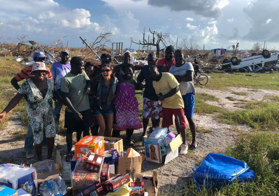 Angela Johnson (center) celebrates with people in Fox Town on Little Abaco Island, the Bahamas, who were stranded by Hurricane Dorian, 15 September 2019. Photo: Angela Johnson