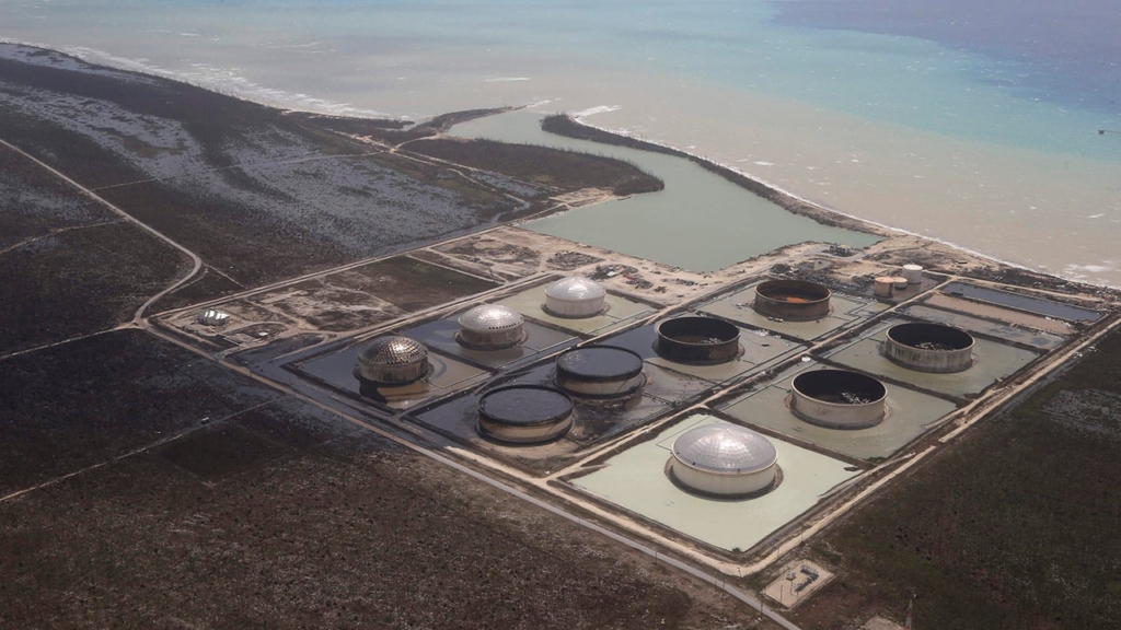 As Category 5 Hurricane Dorian battered the Bahamas, it blew the lids off of six massive crude oil tanks, seen above, causing a spill that may have reached the ocean. Photo: Jim Abernethy / weather.com