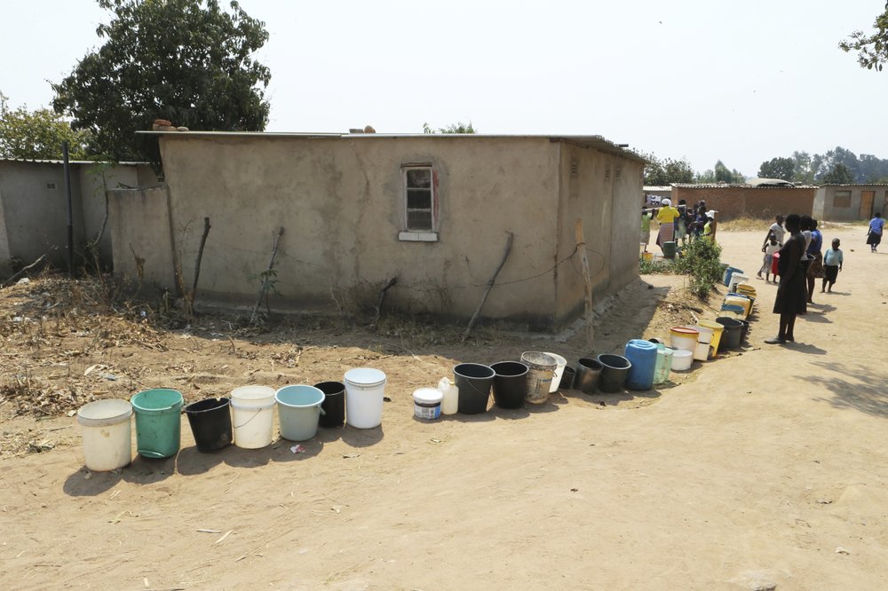 Buckets are seen in a queue to fetch water at a borehole in Harare, Zimbabwe, on Tuesday, 24 September 2019. The more than 2 million residents of Zimbabwe's capital and surrounding towns are now without water after authorities shut down the city's main treatment plant, raising new fears about disease after a recent cholera outbreak while the economy crumbles further. Photo: Tsvangirayi Mukwazhi / AP Photo