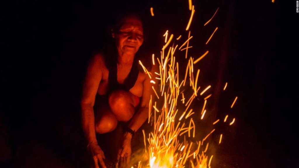 Chief Ajareaty Waiapi builds a bonfire outside her home in Kwapo'ywyry village in the Brazilian state of Amapa, in August 2019. Photo: Apu Gomes / CNN