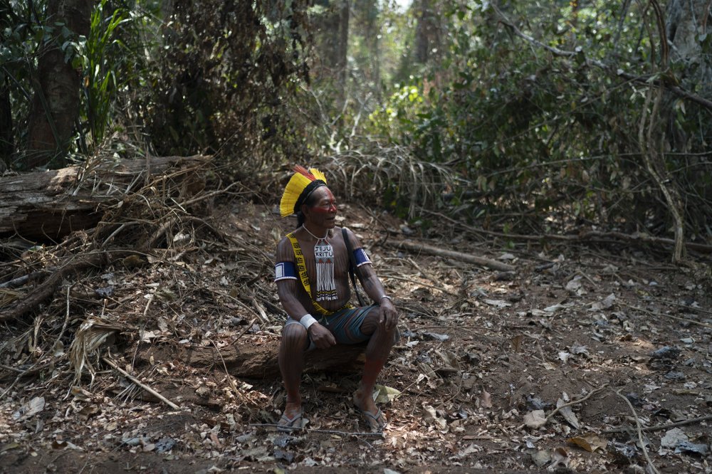 Krimej village indigenous Chief Kadjyre Kayapo, of the Kayapo indigenous community, pauses on the path opened by illegal loggers on the border between Menkragnotire indigenous lands and the Biological Reserve Serra do Cachimbo in Altamira, Para state, Brazil, Saturday, 31 August 2019. He wears a traditional headdress and a necklace reading “Jesus Christ” in Kayapo language. Much of the deforestation in the Brazilian Amazon is done illegally -- land grabbers burn areas to clear land for agriculture and loggers encroach on national forests and indigenous reserves, and Kayapo says he does not want loggers and prospectors on his land. Photo: Leo Correa / AP Photo