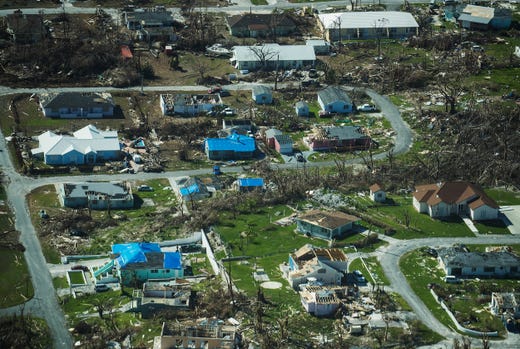 Aerial view of homes in Marsh Harbour on 24 September 2019, about three weeks after the Hurricane Dorian storm slammed the Bahamas. Blue tarps are starting to show up on houses damaged by the storm. Photo: Andrew West / The USA Today Network-Florida