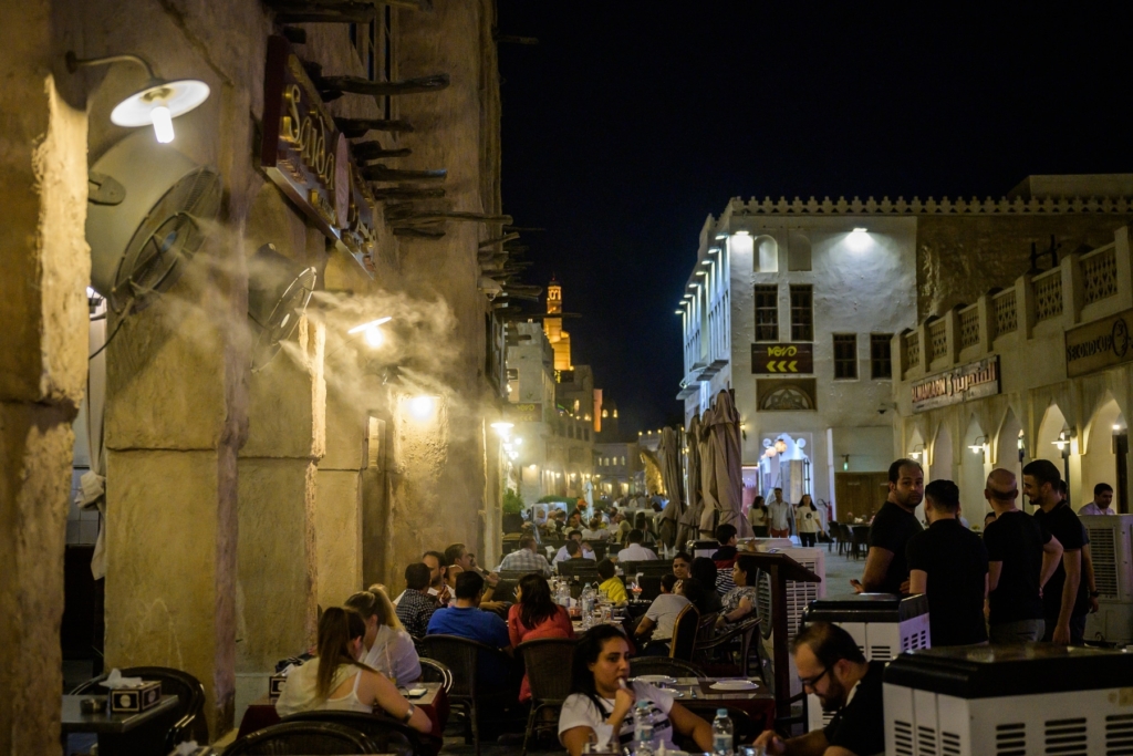 In Doha, Qatar, Fans equipped with misters blow moist air on evening diners who sit beside cooling units. Overnight lows rarely dip below 90 degrees Fahrenheit in the summer. Photo: Salwan Georges / The Washington Post