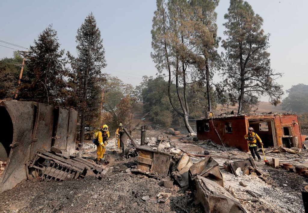 Firefighters look for hot spots in the ruins of charred homes in the Alexander Valley area of Sonoma County, Calif., on Friday, 25 October 2019. Photo: Luis Sinco / Los Angeles Times / TNS
