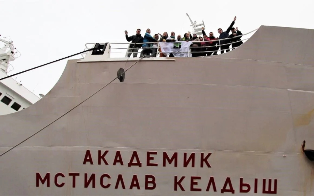 Members of an expedition to find methane seeps in the Arctic Ocean wave from the deck of the “Academic Mstislav Keldysh” before setting out from Arkhangelsk in September 2019. Photo: Tomsk Polytechnic University