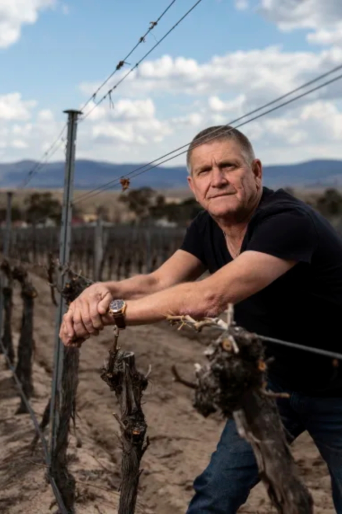 Mike Hayes, a celebrated winemaker in Queensland’s Granite Belt region, stands in a vineyard that’s in danger of a total loss caused by Australia’s historic drought, 4 October 2019. Hayes says, “This is a direct impact of climate change. I don’t care what anybody says.” Photo: Attila Csaszar / Financial Review