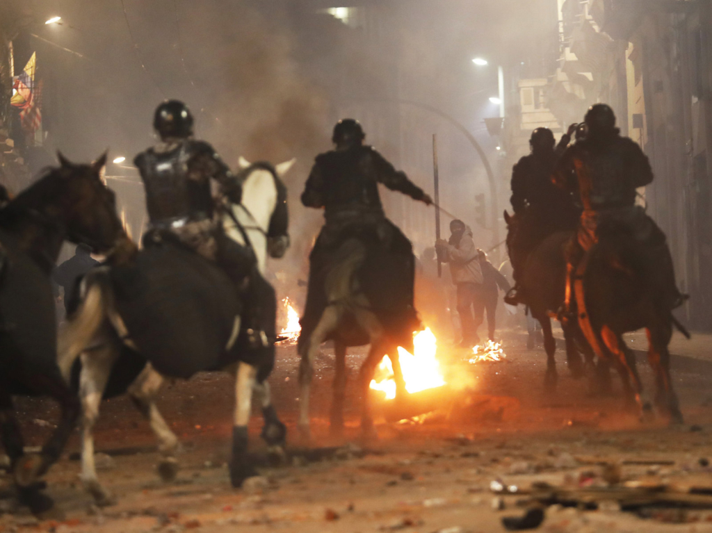 Mounted police in Quito advance on demonstrators protesting Ecuadorian President Lenín Moreno’s move to scrap fuel subsidies, in a clash near the government palace late Thursday, 3 October 2019. Photo: Dolores Ochoa / AP