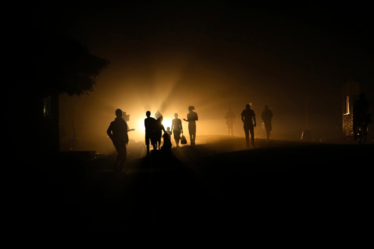 People walk home in the dark due to power shortages in Harare, on Monday, 30 September 2019. Zimbabwean President Emmerson Mnangagwa presented a State of the Nation address on 1 October 2019, at a time the southern African nation is reeling from its worst economic crisis in more than a decade. Zimbabweans are enduring shortages of everything from medicines, fuel, cash and water, bringing a weariness and disgust that has often flared into streets protests. Opposition lawmakers walk out of president’s speech. Photo: Tsvangirayi Mukwazhi / Associated Press