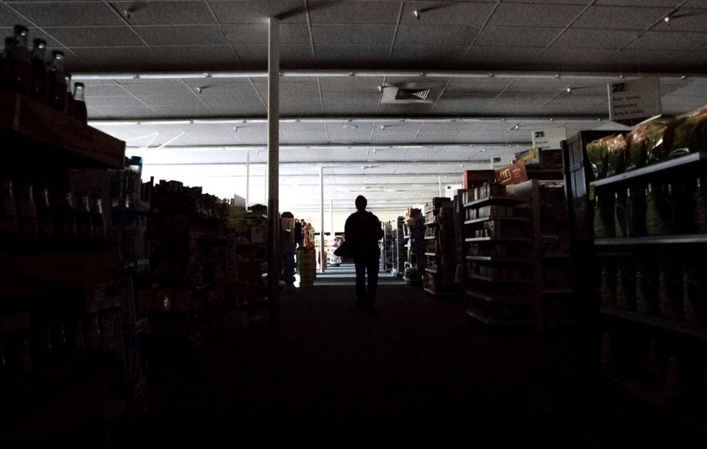 Shift supervisor James Quinn walks through a darkened CVS Pharmacy in downtown Sonoma, California, after Pacific Gas & Electric cut power on 9 October 2019. Photo: Noah Berger
