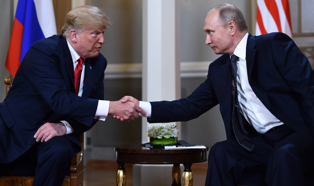 U.S. President Donald Trump shakes hands with Russian President Vladimir Putin before their closed-door meeting in Helsinki, Finland, on 16 July 2018. Photo: Brendan Smialowski / AFP / Getty Images