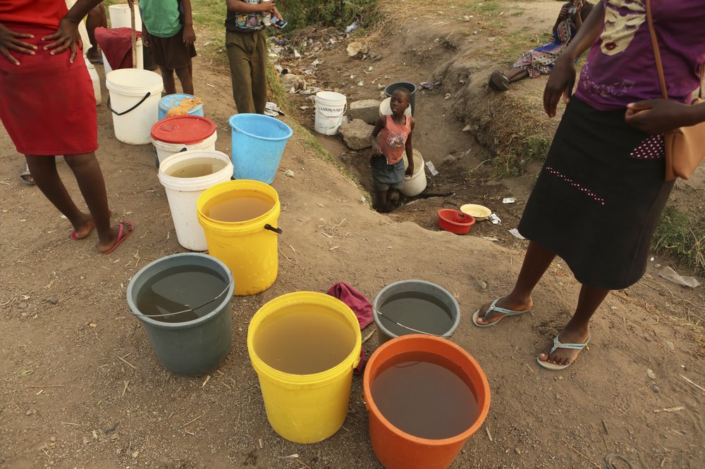 Women and children wait to collect water from an underground source in Harare, on 30 September 2019. Photo: Tsvangirayi Mukwazhi / Associated Press