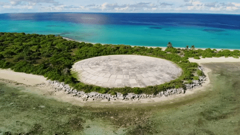 Aerial view of Runit Dome, in Enewetak Atoll, the Marshall Islands, where more than 3.1 million cubic feet of U.S.-produced radioactive soil and debris, including lethal amounts of plutonium, are buried. The so-called “Tomb” now bobs with the tide, sucking in and flushing out radioactive water into nearby coral reefs, contaminating marine life. Video: Carolyn Cole / Los Angeles Times