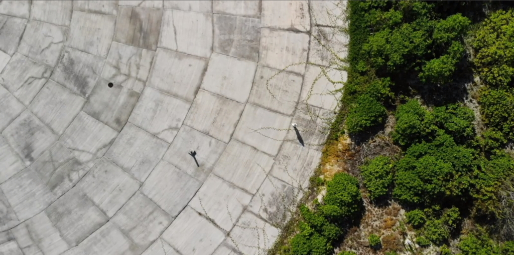 Aerial view of Runit Dome, in Enewetak Atoll, the Marshall Islands, where more than 3.1 million cubic feet of U.S.-produced radioactive soil and debris, including lethal amounts of plutonium, are buried. The so-called “Tomb” now bobs with the tide, sucking in and flushing out radioactive water into nearby coral reefs, contaminating marine life. Photo: Carolyn Cole / Los Angeles Times