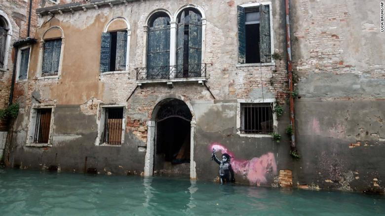 Banksy's migrant child mural is partially submerged in Venice, Italy, Friday, 15 November 2019. Exceptionally high tidal waters returned to Venice on Friday, prompting the mayor to close the iconic St. Mark's Square and call for donations to repair the Italian lagoon city just three days after it experienced its worst flooding in 50 years. Photo: Luca Bruno / AP Photo