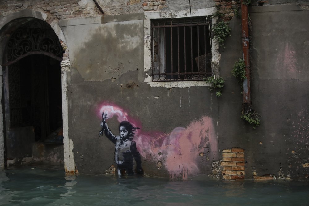 Banksy’s migrant child mural is partially submerged in Venice Italy, 15 November 2019. Photo: Luca Bruno / AP Photo
