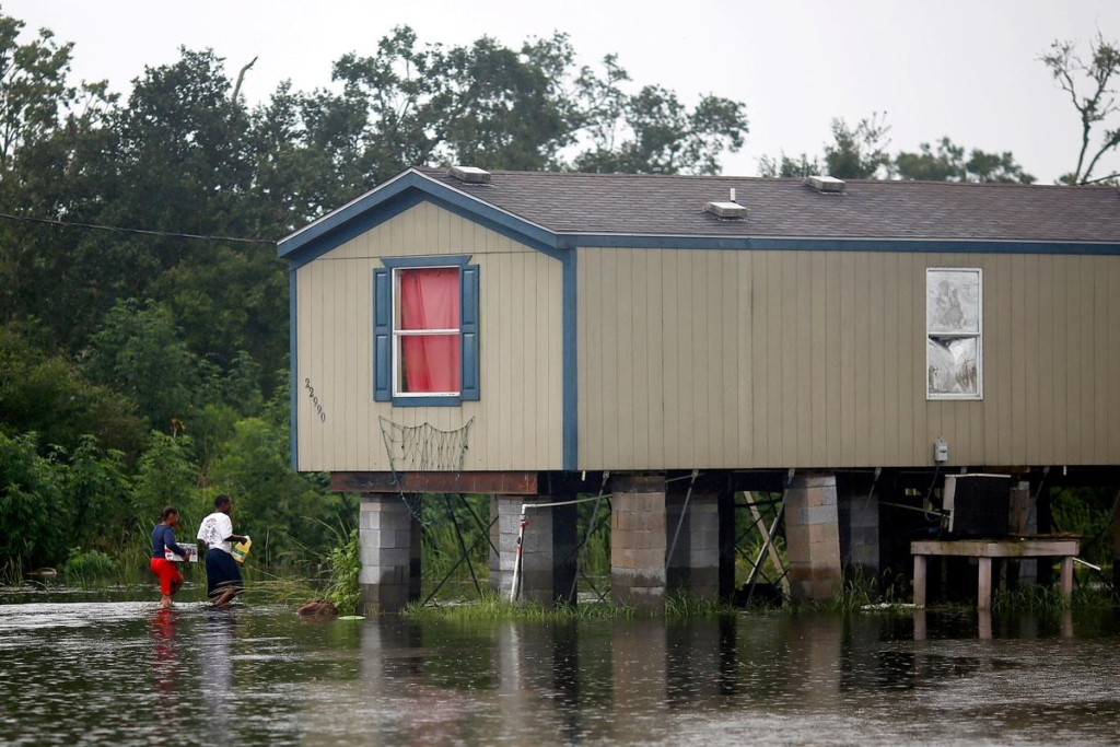 Residents walk through flood water back to their raised house during Hurricane Barry in Plaquemines Parish, Louisiana, U.S., on 14 July 2019. Photo: Jonathan Bachman / REUTERS