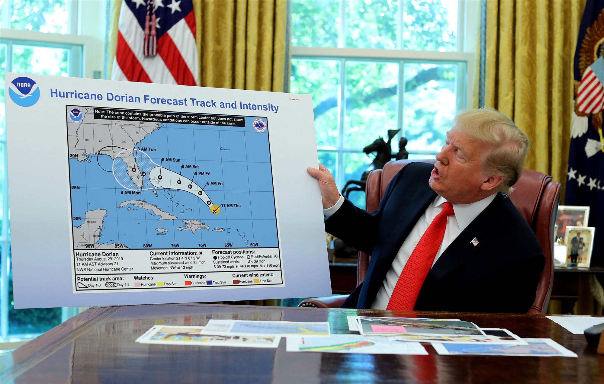 Trump holds an early projection map of Hurricane Dorian in the Oval Office on 4 September 2019. The projected path of the hurricane has been extended into Alabama with a Sharpie pen, almost certainly by Trump himself. Photo: Jonathan Ernst / Reuters