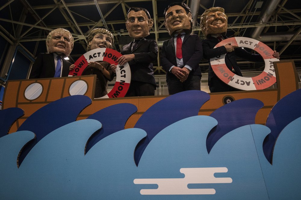 From left to right: activists of Oxfam International depicting Britain's Prime Minister Boris Johnson, German Chancellor Angela Merkel, French President Emmanuel Macron, Canadian Prime Minister Justin Trudeau and US President Donald Trump stage a stunt highlighting global warming and the rise of sea levels at the COP25 summit in Madrid, Tuesday 10 December 2019. Photo: AP Photo