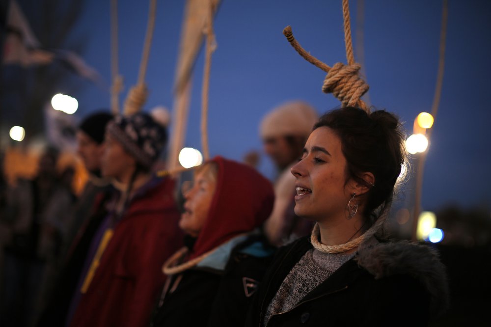 Extinction Rebellion activists wear nooses around their necks in protest outside of the COP25 climate talks congress in Madrid, Spain, Saturday, 14 December 2019. The marathon international climate talks ended with no agreement on carbon markets. Photo: Manu Fernandez / AP Photo