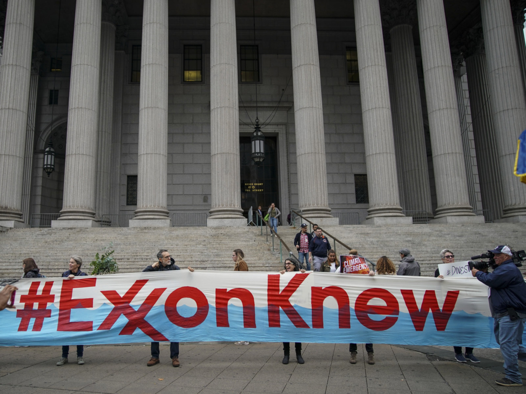 Environmental activists rally outside of New York Supreme Court in October 2019 in Manhattan, on the first day of the trial accusing ExxonMobil of misleading shareholders about its climate change accounting. Photo: Drew Angerer / Getty Images