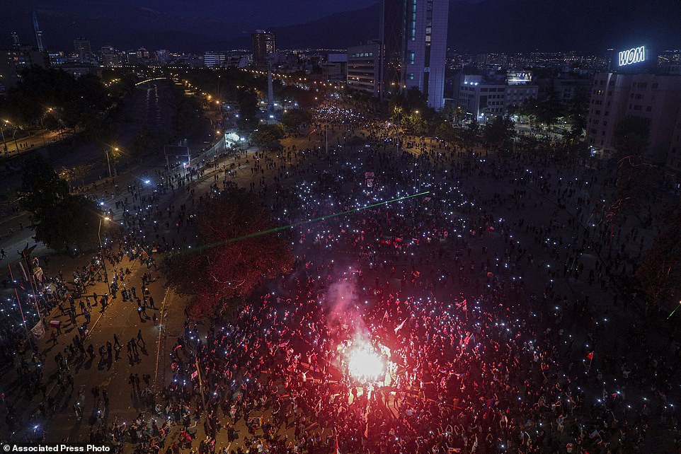 People gather for an anti-government protest in Santiago, Chile, Friday, 1 November 2019. Groups of Chileans continued to demonstrate as government and opposition leaders debated the response to weeks of protests that paralyzed much of the capital and forced the cancellation of two major international summits. Photo: AP Photo