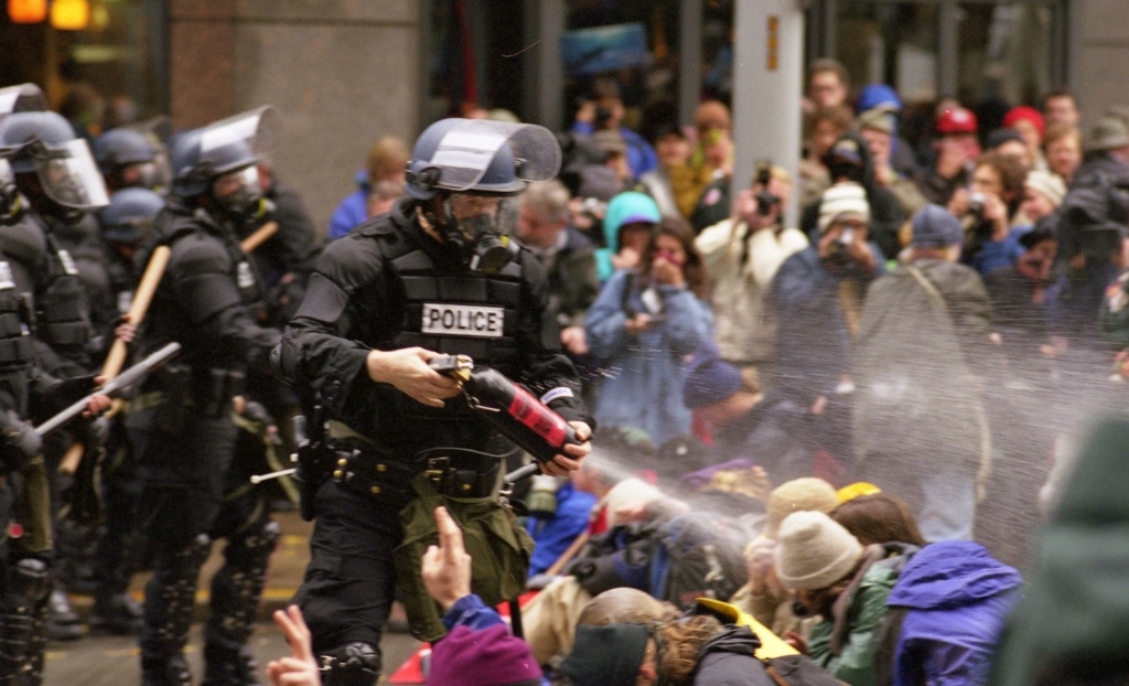 Seattle police blast pepper spray at nonviolent protesters during the WTO protests on 30 November 2019. Photo: Steve Kaiser